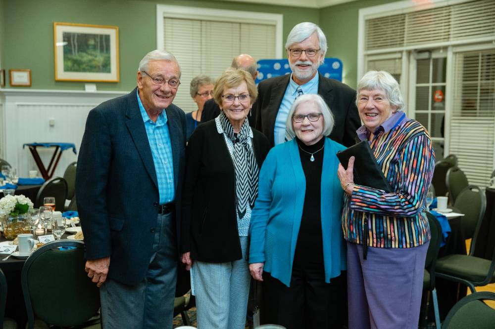 Group photo of five alumni at the Reunion Dinner.